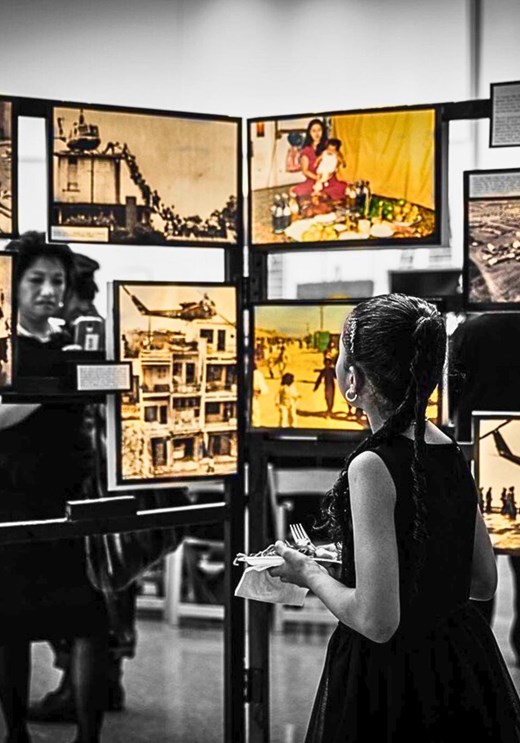 A visitor encountering a set of historical photographs that were part of the 2023 Vietnamese American Roundtable’s annual commemoration for the end of the Vietnam war in San Jose. Like the organizers of this event, many in the Vietnamese diasporic community in the United States commemorate the war’s end on April 30th as “Black April” (Tháng Tư Đen) in sharp contrast to the celebrations that mark official Vietnamese state commemorations where the anniversary is called Reunification Day (Ngày Thống nhất) or the Day of the Liberation of the South (Ngày Giải phòng miền Nam). Photo courtesy of the Vietnamese American Roundtable.