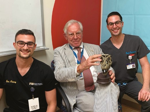 The “Dynosaur” with his award from Bar and Austin, Florida International University Herbert Wertheim College of Medicine medical students.