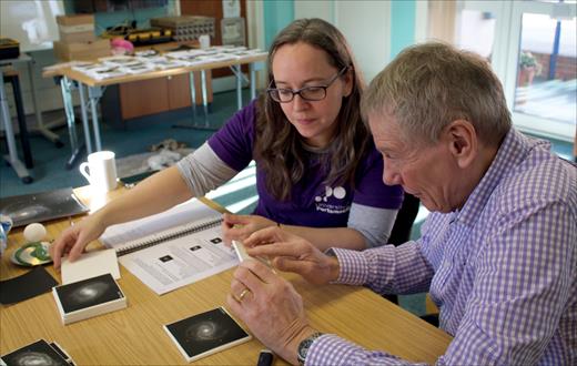 Karen Masters helps attendee Brian Anderson at a public event. (Jen Gupta/Tactile Universe team)