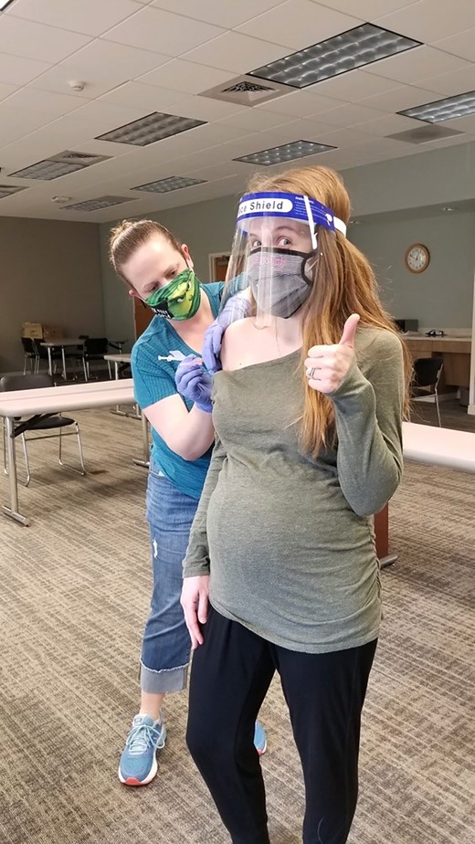 Heather vaccinates Jenny for COVID-19.
