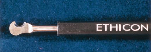 Photograph of hook-shaped blade of the Harmonic Scalpel with hard sheath (HDH14) which eliminates heat injury to the skin.