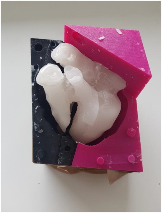 Silicone mould surrounding the hard wax, silicone can be poured between them.