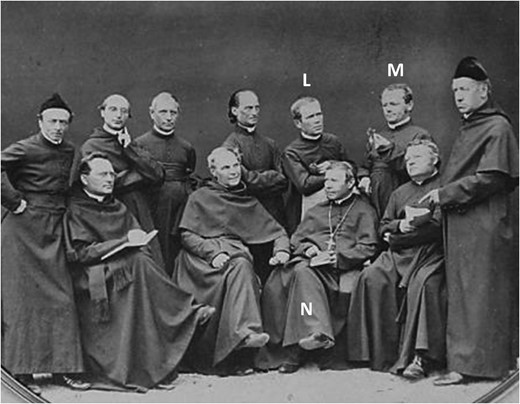 A photograph of the brothers the Augustinian Community of St Thomas Monastery in Brünn ∼1862. Abbot Cyrill Napp (N) is seated with the pectoral cross and bible, wearing a pileolus. He is flanked by Gregor Mendel (M) and Joseph Lindenthal (L), both leaning on his chair. Lindenthal helped Mendel with his crossing experiments (Iltis 1924). Both hold a flower in their hand. From the symbolism of the objects associated with each person, it is clear that the photo is arranged and it is probably no coincidence that Napp, with his interest in inheritance, is flanked by the two plant breeders. Courtesy of the Mendel Museum of Masaryk University, Brno, Czech Republic.