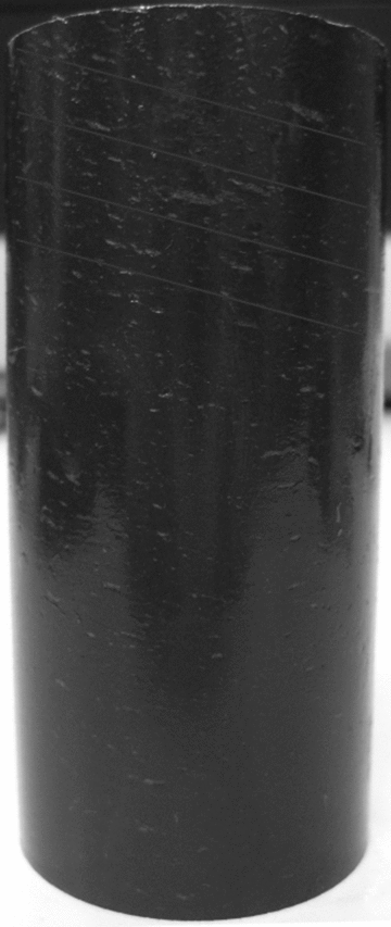 A cylindrical shale sample from the Opalinus Clay formation in Switzerland. The grey lines indicate the apparent orientation of the shale bedding plane.