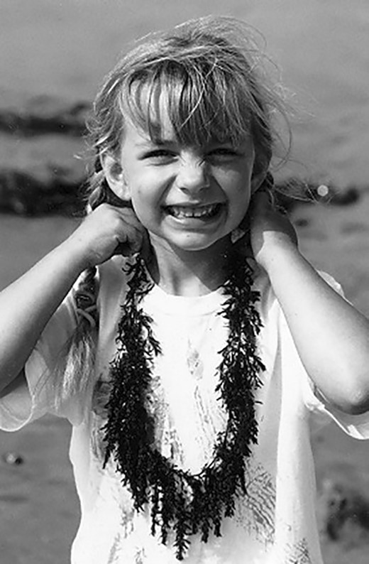 Kelsey with a seaweed necklace at Cardiff State Beach in 2001.