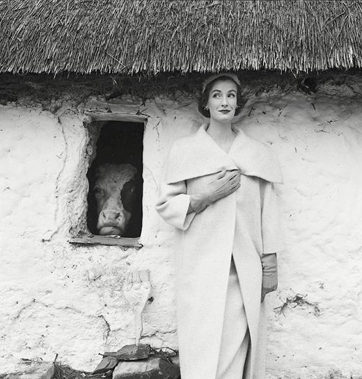 Norman Parkinson shot of Sybil Connolly wool coat, 1954 Vogue magazine. Wenda Parkinson, the wife of photographer Norman Parkinson, models a Sybil Connolly white Irish wool coat outside a thatched cow byre. The image illustrated a feature on Dublin in the March 1954 issue of Vogue. Photo courtesy of the Norman Parkinson estate.