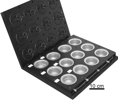 Double biofilm analyzer (DBA) instrument with the lid open. The instrument consists of a platform with holders for 12 stainless steel vials of which six were individually polarizable. Each vial was provided with a wire electrode and a lid-mounted reference electrode so that they reached the vial when closing the lid. The vial operated as the counter electrode. The DBA instrument was operated in a rotating thermostatic incubator (45°C) that provided a liquid flow of 0.3 m s−1 in each vial