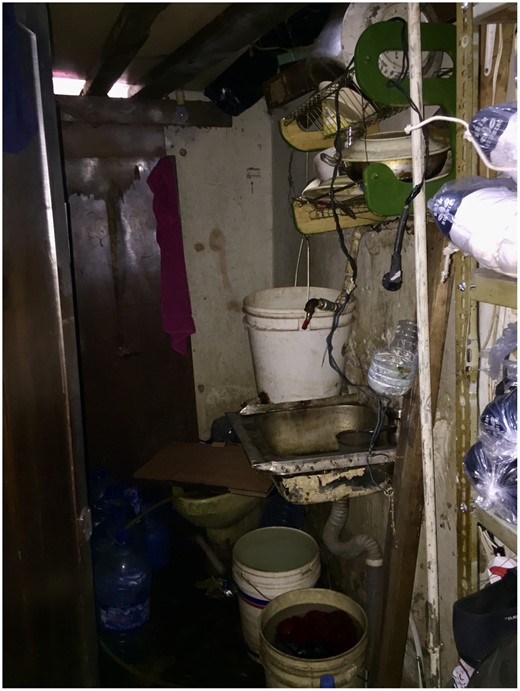 Makeshift Toilet and Kitchen in the Backroom of a Commercial Space