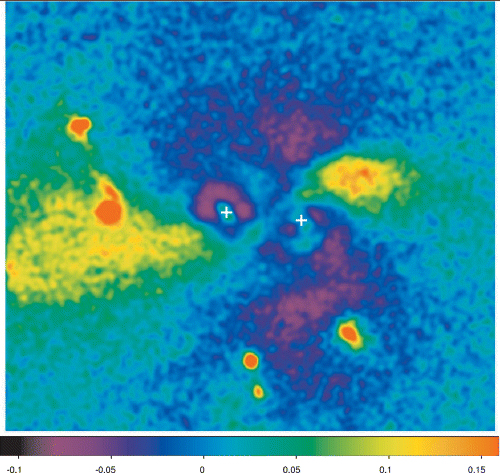 The normalized residuals (residuals/model) obtained by subtracting from the HST images a model consisting of two de Vaucouleurs light profiles. Crosses mark the centroids of the two galaxies.