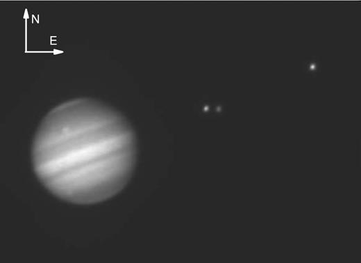 Image of Jupiter, Io, Europa and Calisto (left to right) obtained with the 0.6 m diameter Zeiss telescope, equipped with a methane filter. The planet and the satellites present about the same brightness. Due to the use of this filter, centred at λ = 890 nm with 20 nm width, the scattered light from Jupiter is severely minimized.