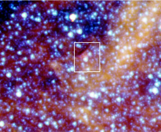 Colour composite Spitzer IRAC image of WR 102ka. Red is at ∼8 μm, green is at ∼5.8 μm and blue is at ∼3.6 μm. The white box illustrates the area covered in our SINFONI observation. Image size is 2.9 arcmin × 3.6 arcmin. North is up and east is to the left.