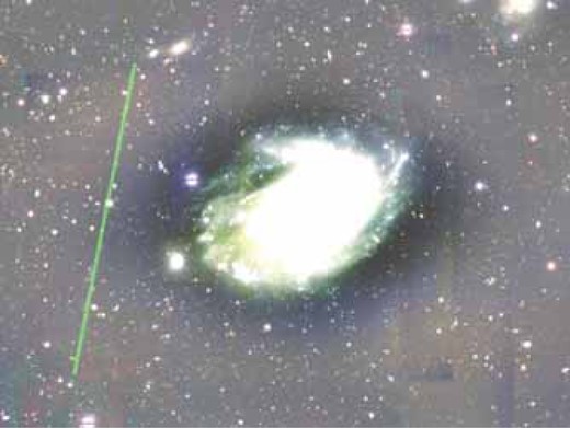 Remaining satellite trail (the slanted line on the left) and the over-subtracted sky background around the large galaxy at the center. The level is stretched to enhance the background. The image is approximately 9΄ × 7΄. (Color online)