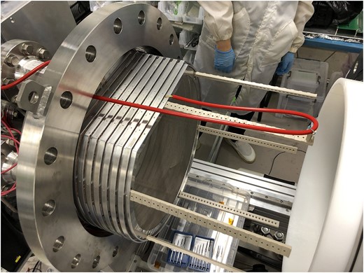 Photograph of the field cage installed in the pressure vessel. The white cylinder on the right side is the HDPE insulator.